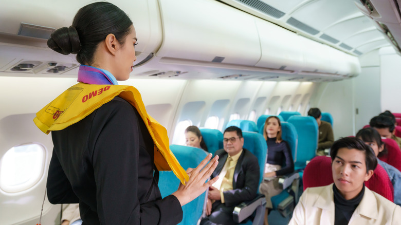 Flight attendant performing a safety briefing