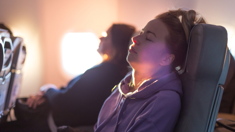 woman sleeping in plane