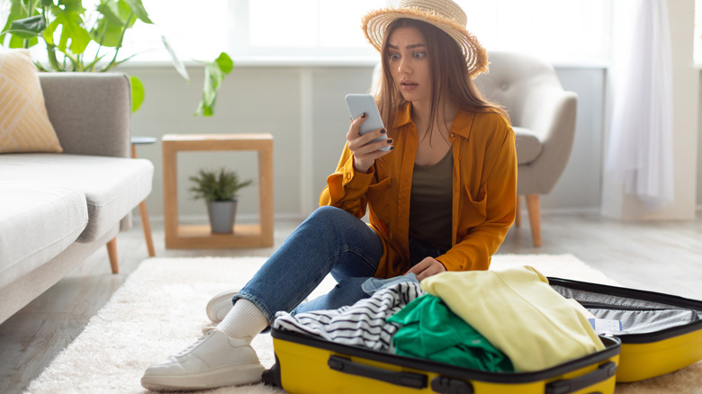 shocked woman near luggage