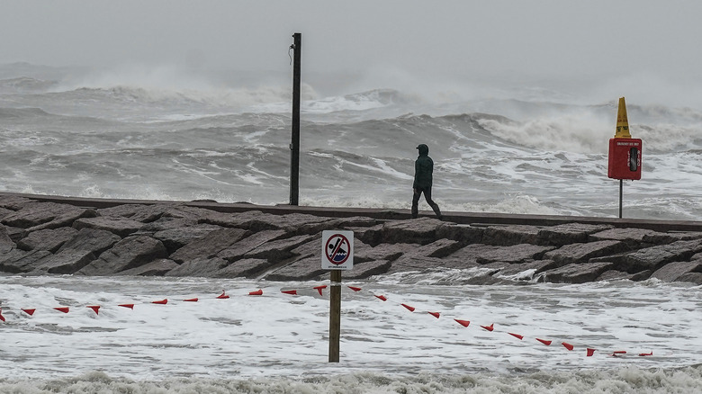 a man walks along a jetty