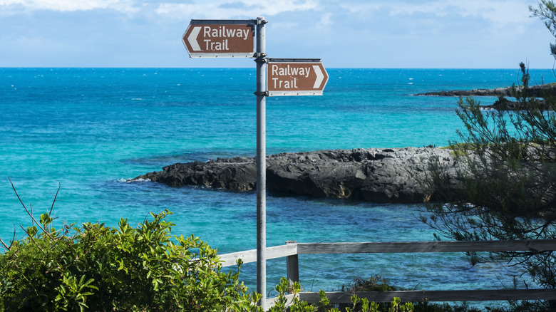 Railway Trail signs near ocean