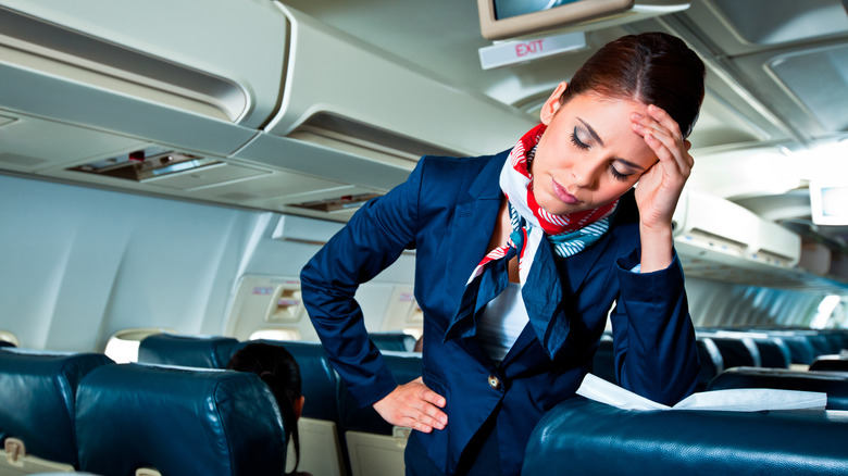 Annoyed flight attendant on a plane