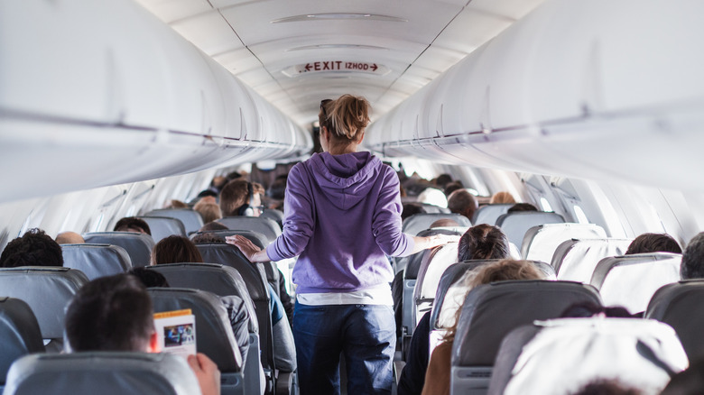 Person in the aisle of a plane