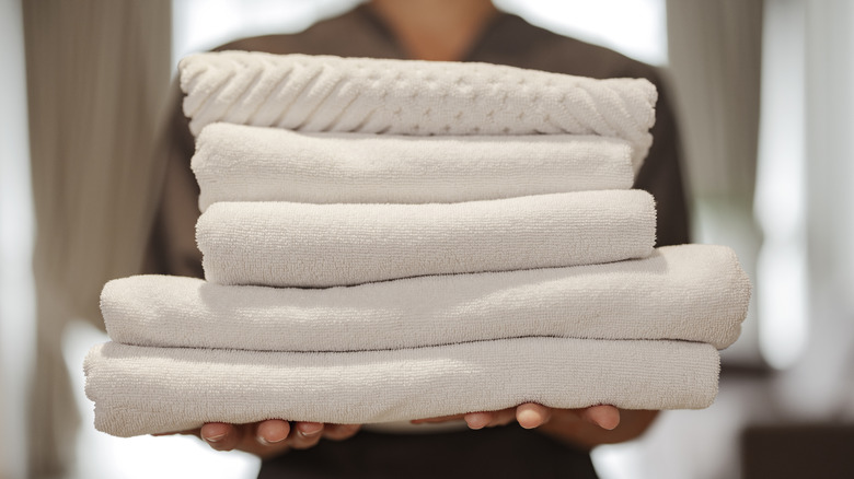 Hotel worker holding towels