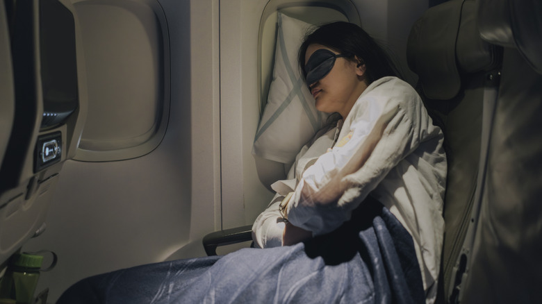 Person sleeping mid-flight