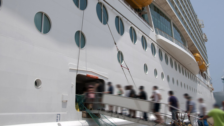 a timelapse of passengers embarking on a cruise ship in port