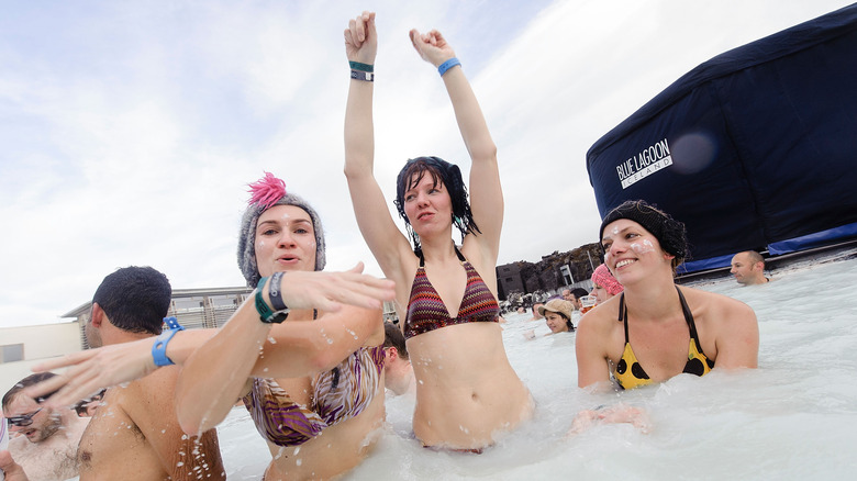 People enjoying the popular Blue Lagoon baths in Iceland