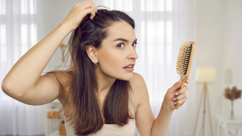 Woman inspecting her scalp