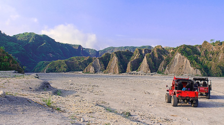 Jeep driving through dramatic landscape