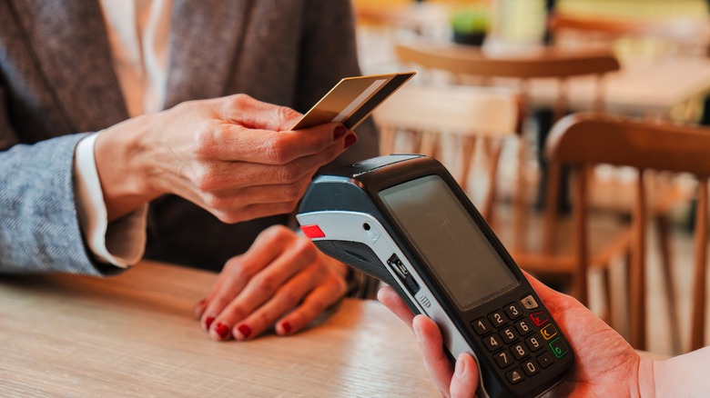 Person paying on a machine at a restaurant