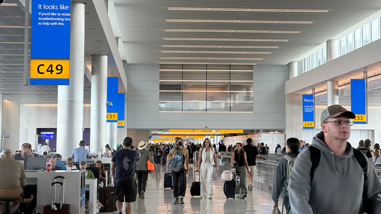 People inside an airport, heading to their gates