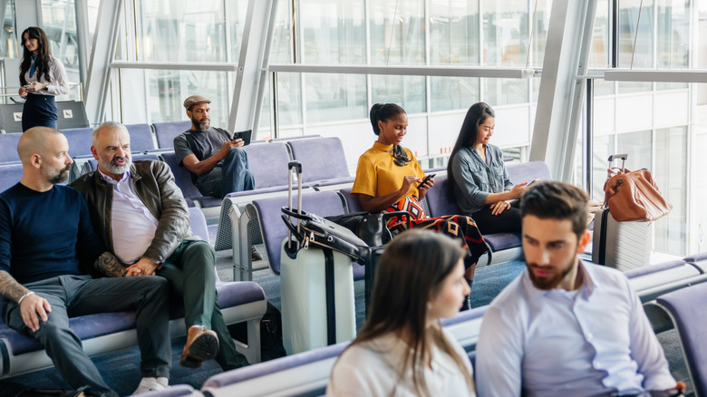 People sitting and waiting at an airport gate