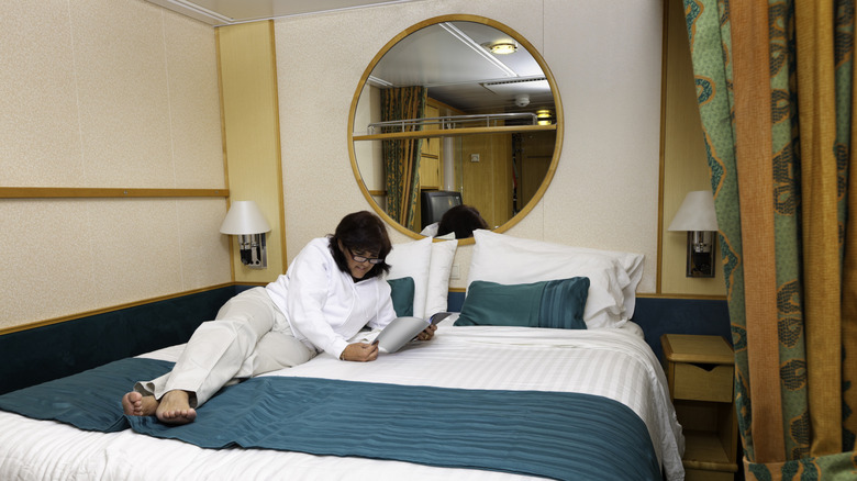 Woman reading in an inside cabin on a cruise