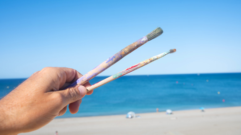 two paintbrushes at the beach