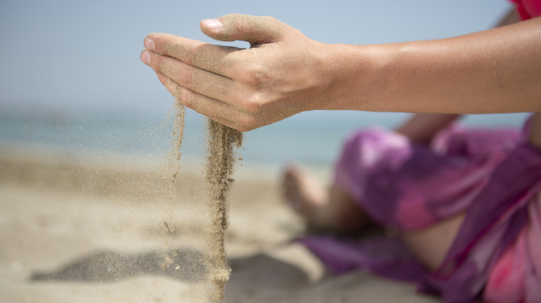 Sand running through hands