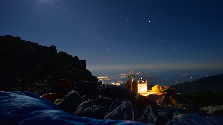 Some campers watch the stars from their sleeping bags