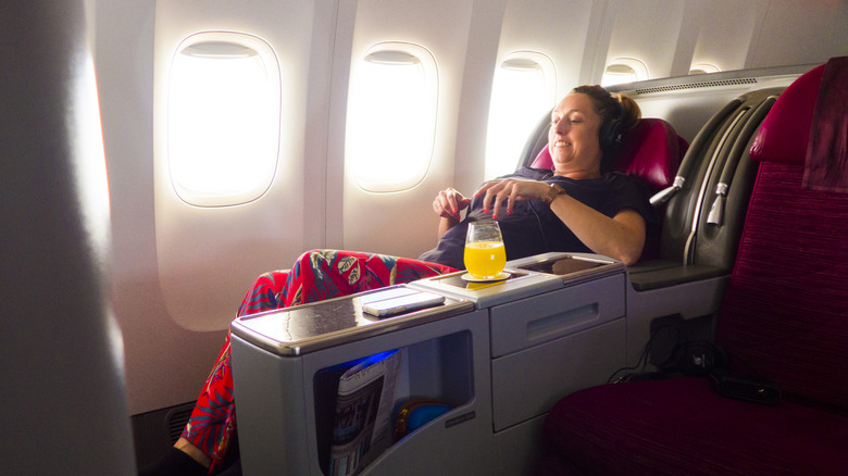 Woman flying in business class