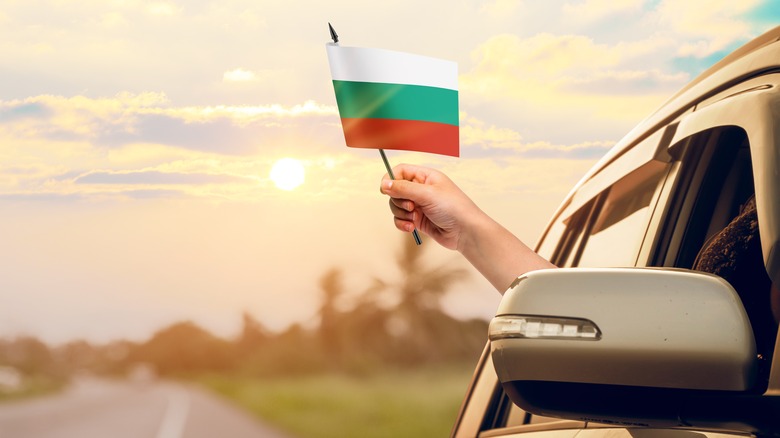 The Bulgarian flag is flown out of a car window