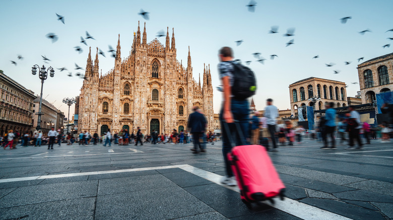 A man walking toward the Milan Cathedral