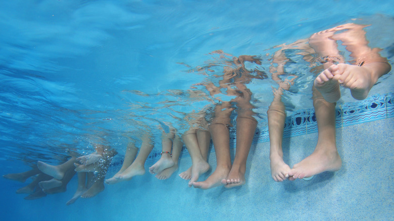 A person standing by a pool