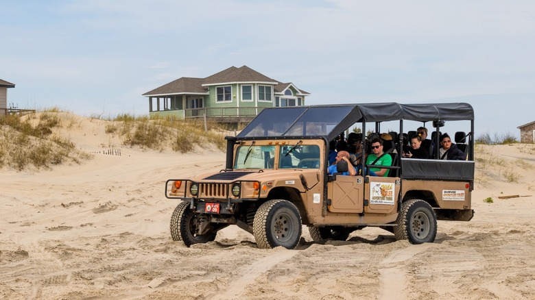 Tourists riding the passanger vehicles during a horse safari