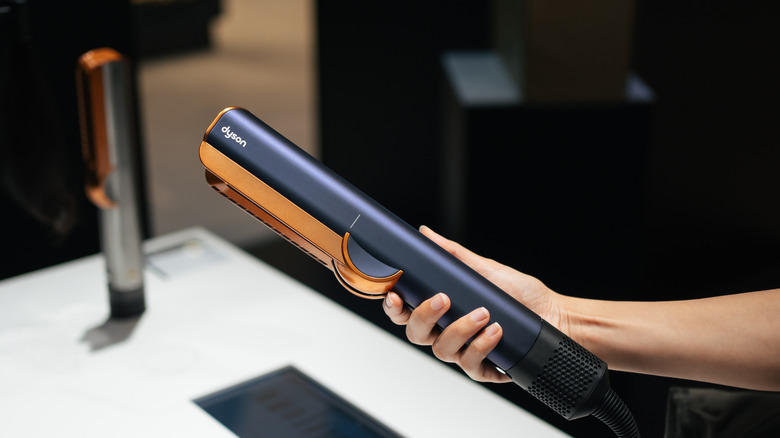 Female hand holding Dyson hair tool