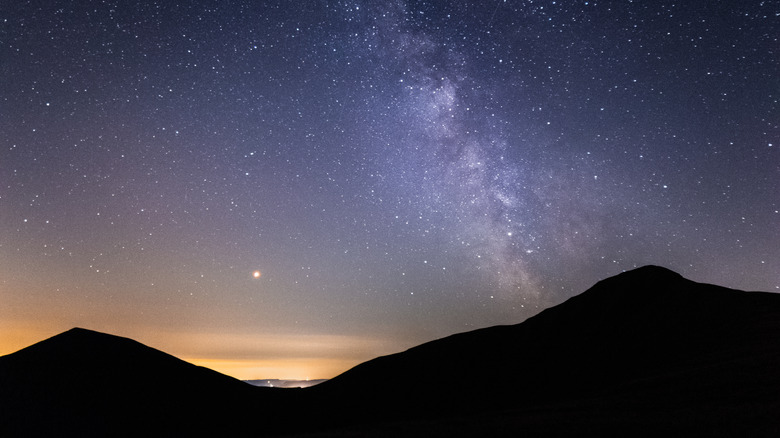 Milky Way in the night sky over Brecon Beacons mountains in Wales