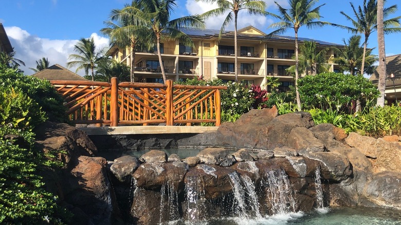 Bridge over a waterfall at Koloa Landing Resort