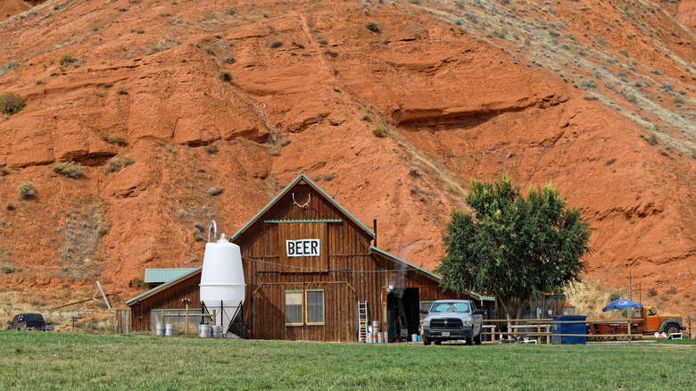 Wooden brewery barn against a red cliff