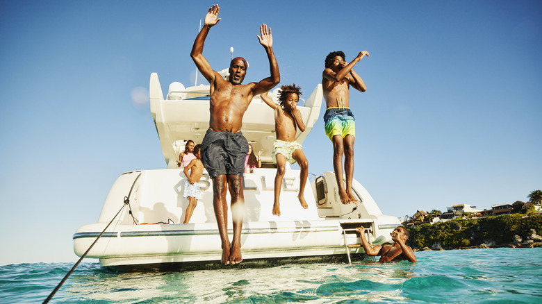 Family jumping off a boat