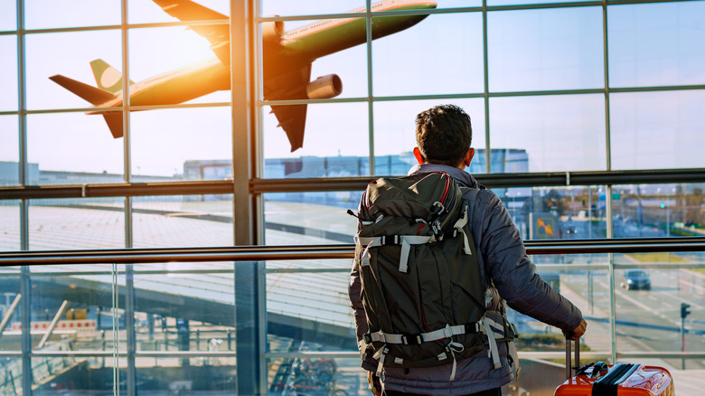 Person watching plane at airport