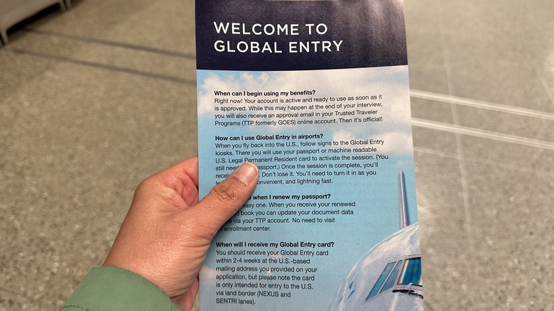 Person holding a Global Entry flyer