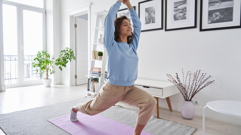 Woman doing yoga in room