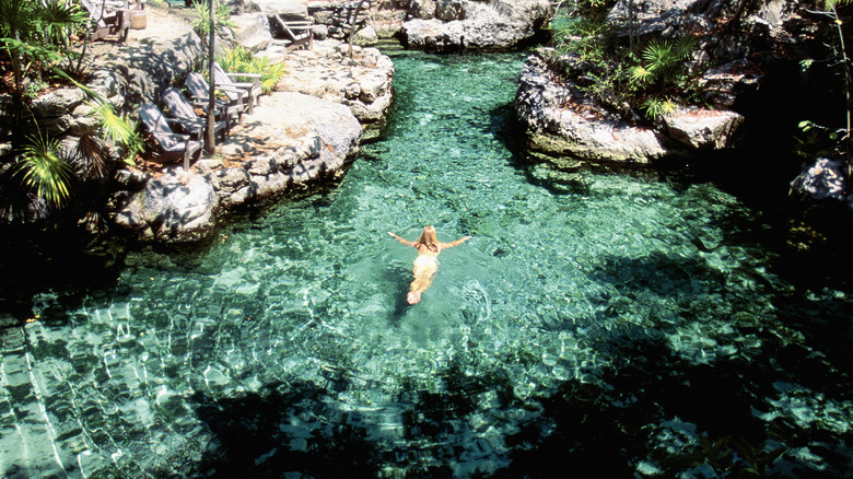 Woman swimming in a natural pool