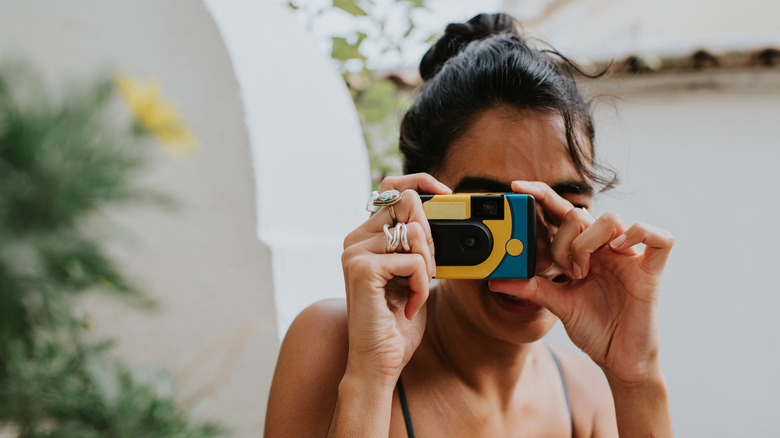 Woman using a disposable camera