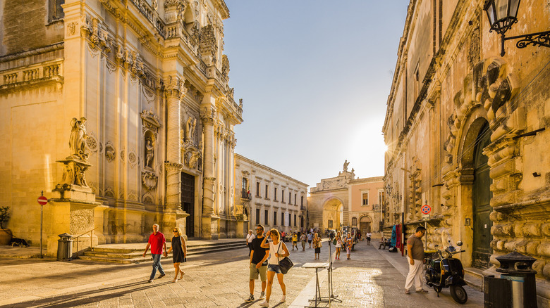 People walking on a stone street in Salento, Italy