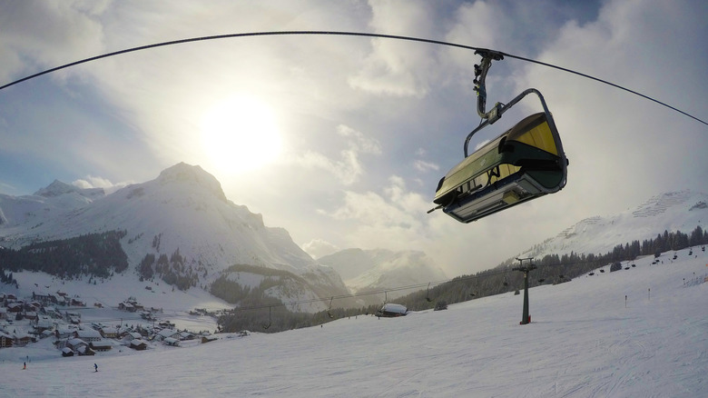 a chairlift flying over the snowy mountain landscape in Lech, Austria