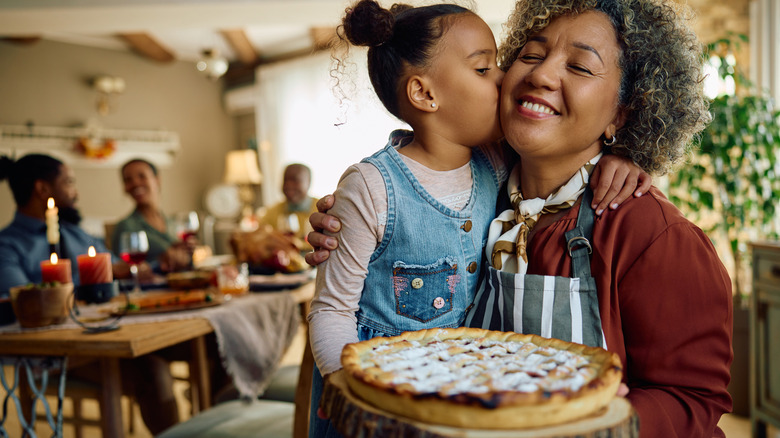 Grandmother and child making pie