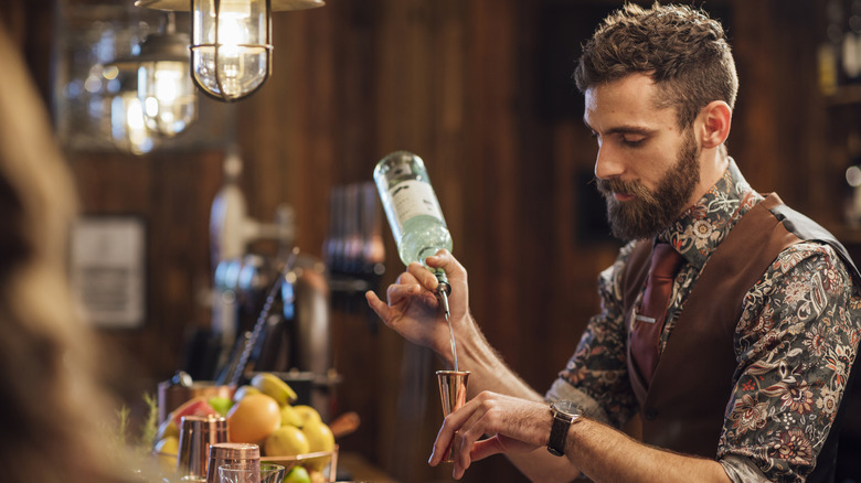 A bartender shaking a drink