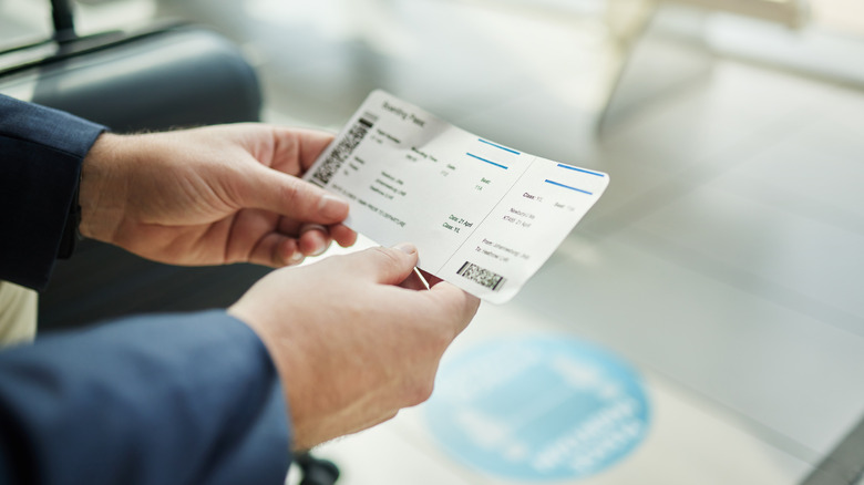 Traveler holding their boarding pass