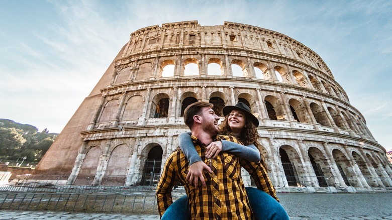 Happy romantic couple in front of Collesium