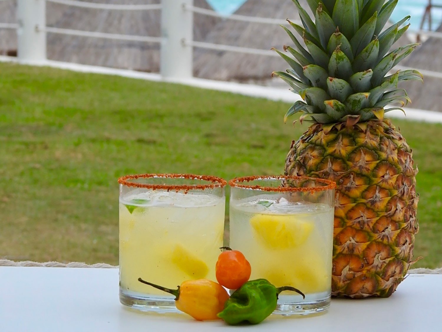 Two pineapple margaritas on a table.