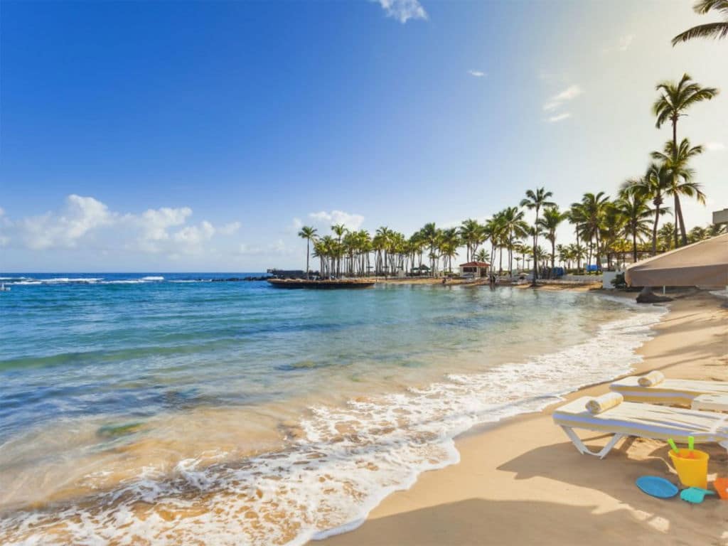 Waves crash on the shores of a beach resort.