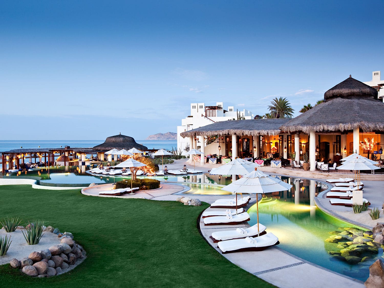 An arrangement of lounge chairs around a lounge pool.