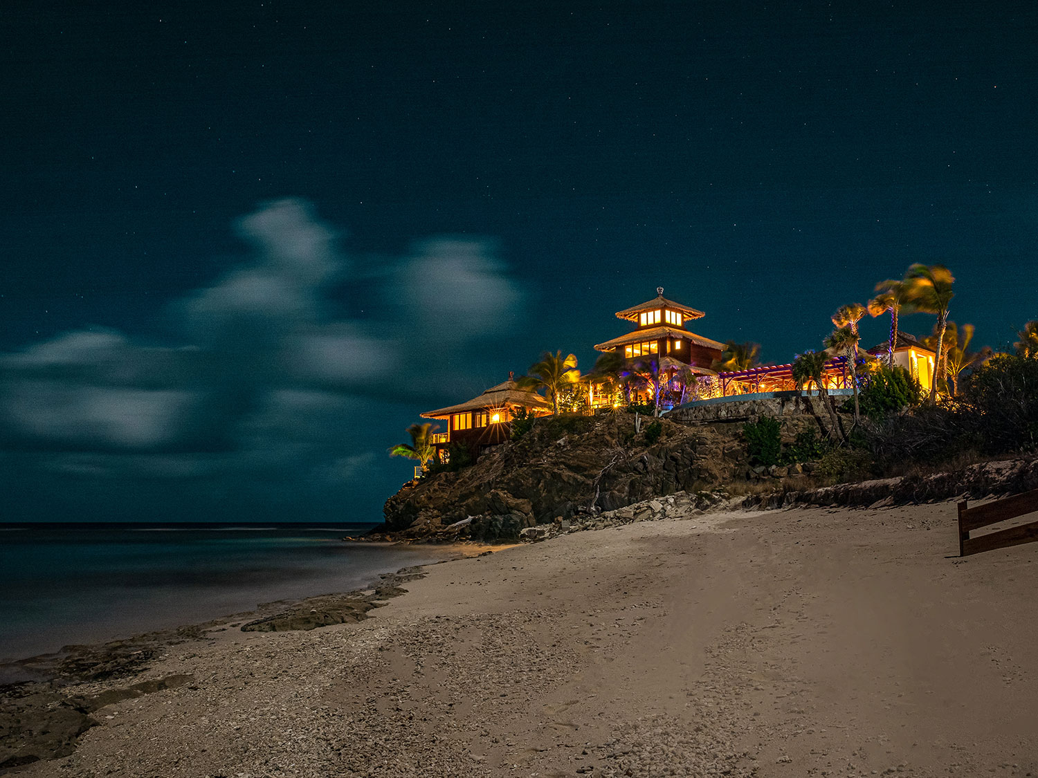 A beach resort lit up at night.