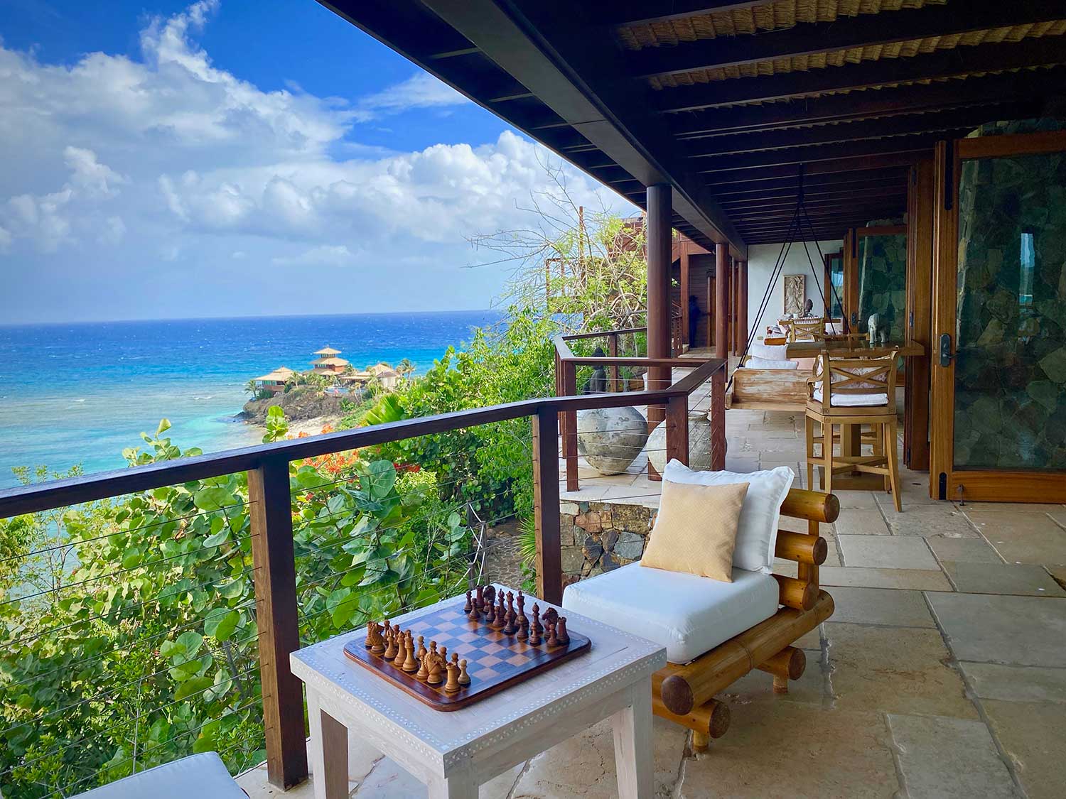 A resort porch overlooking a beach on Necker Island.