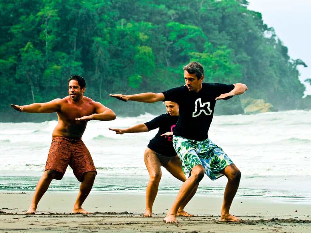 An instructor gives guests surfing lessons on the beach at the Kalon Surf resort in Costa Rica.